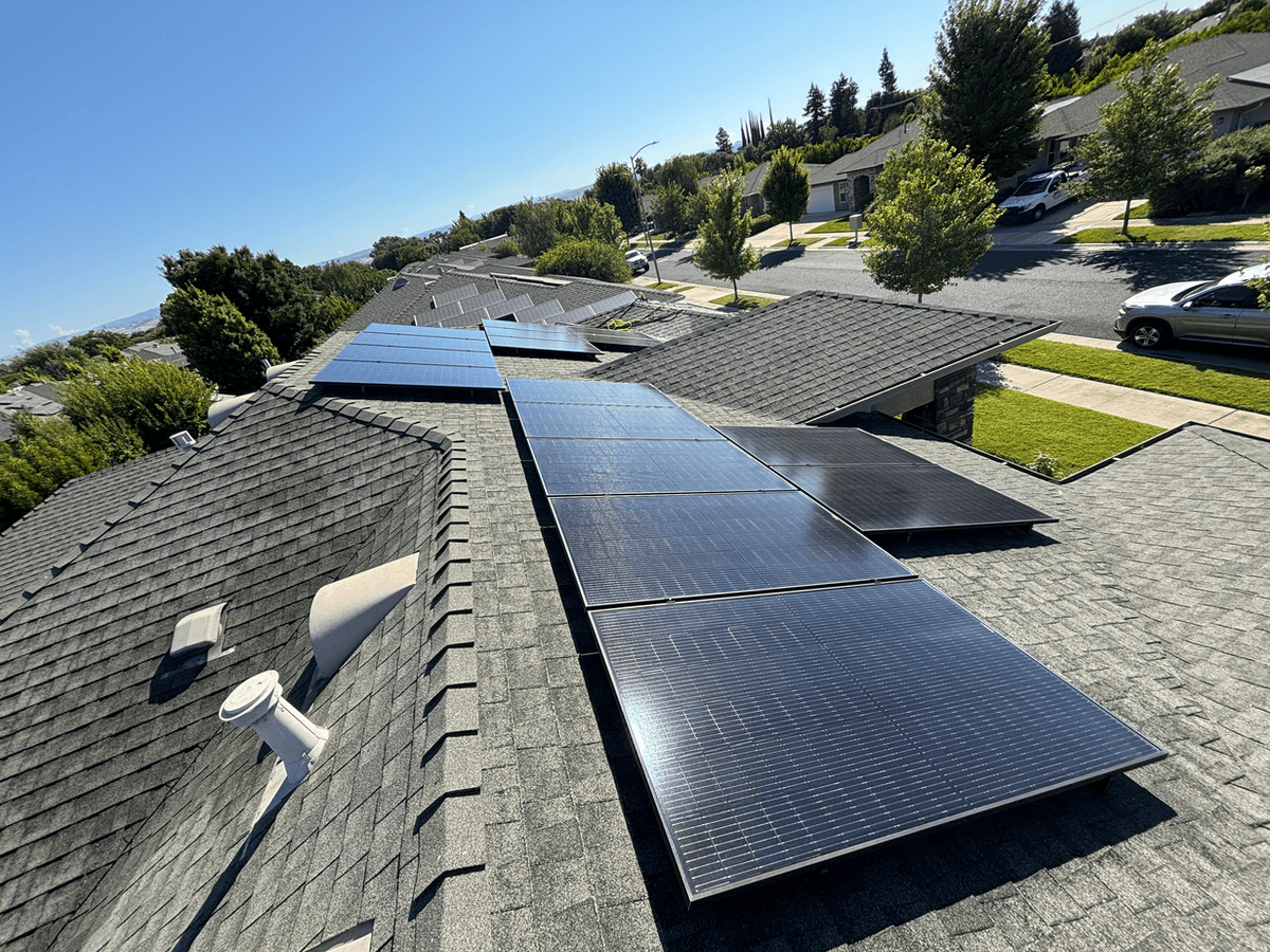 Rooftop solar panel installation on a residential shingle roof